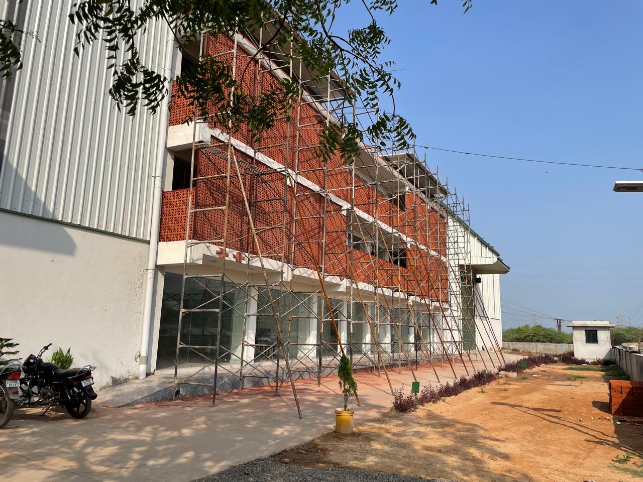 Terracotta screened workplace frontage under construction at Greenway factory